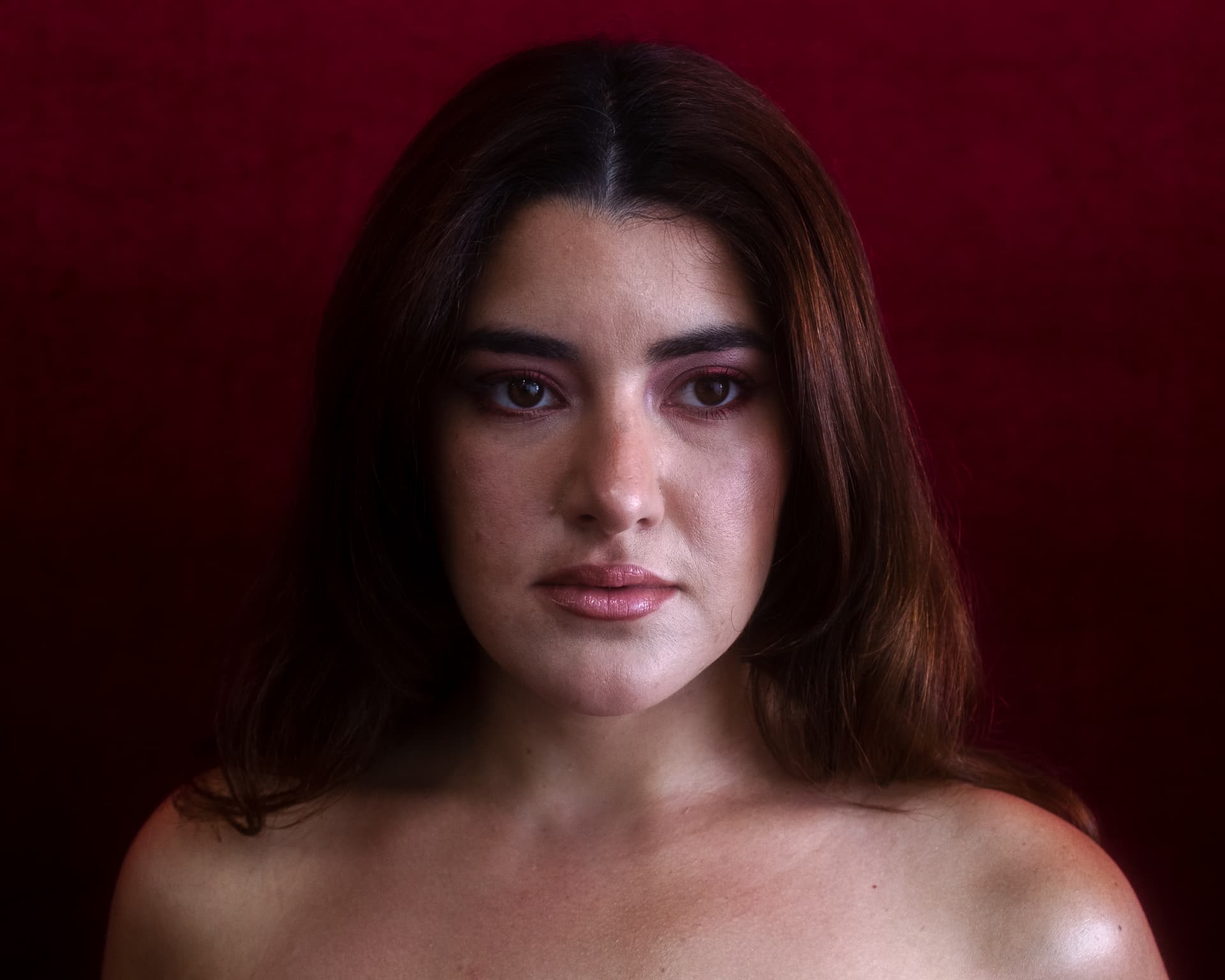 Close portrait of Leeza Maroe in soft red light